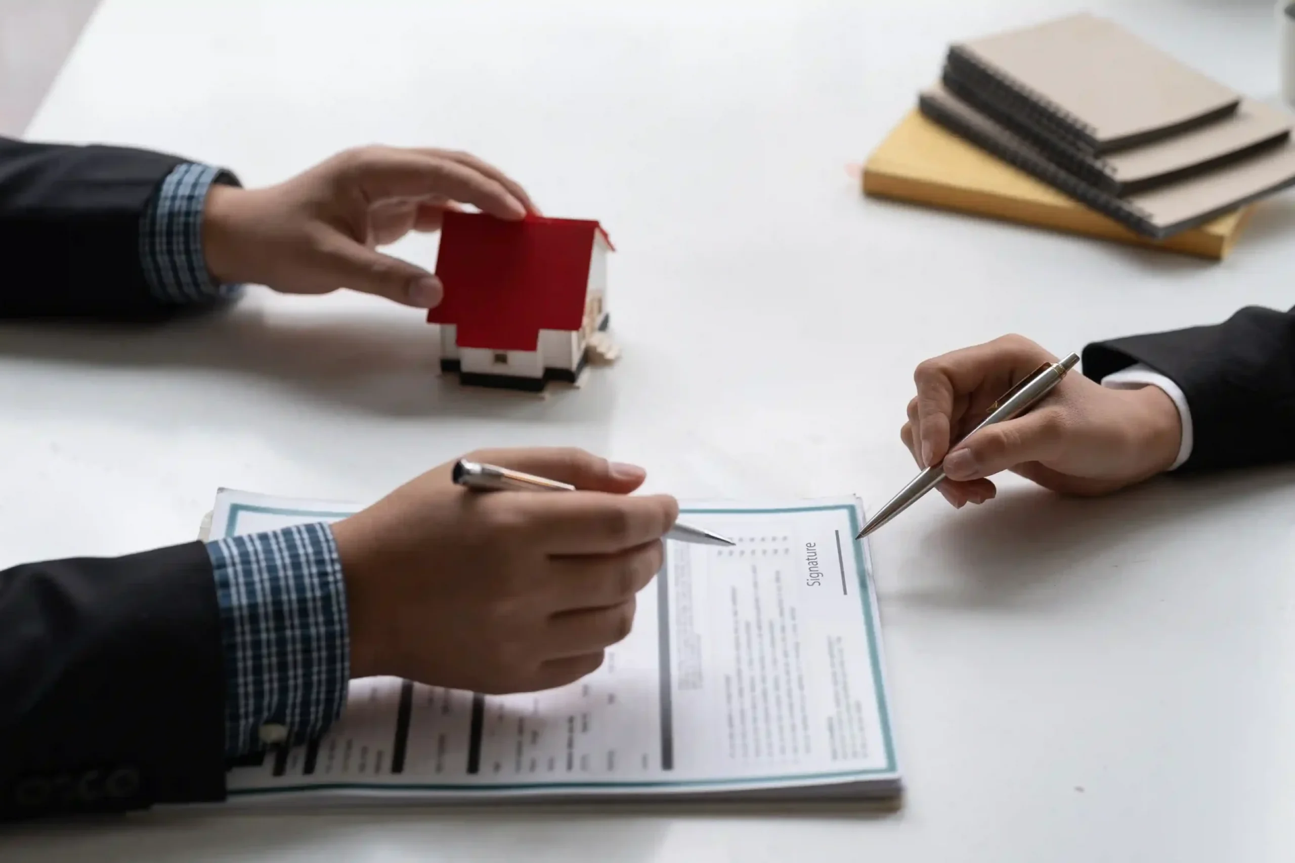 businessman-estate-agent-signing-document-house-deal_11zon